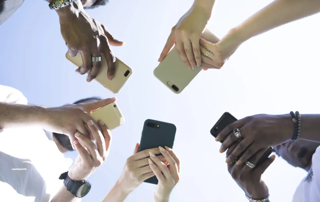 bottom-view-diverse-group-friends-with-phones