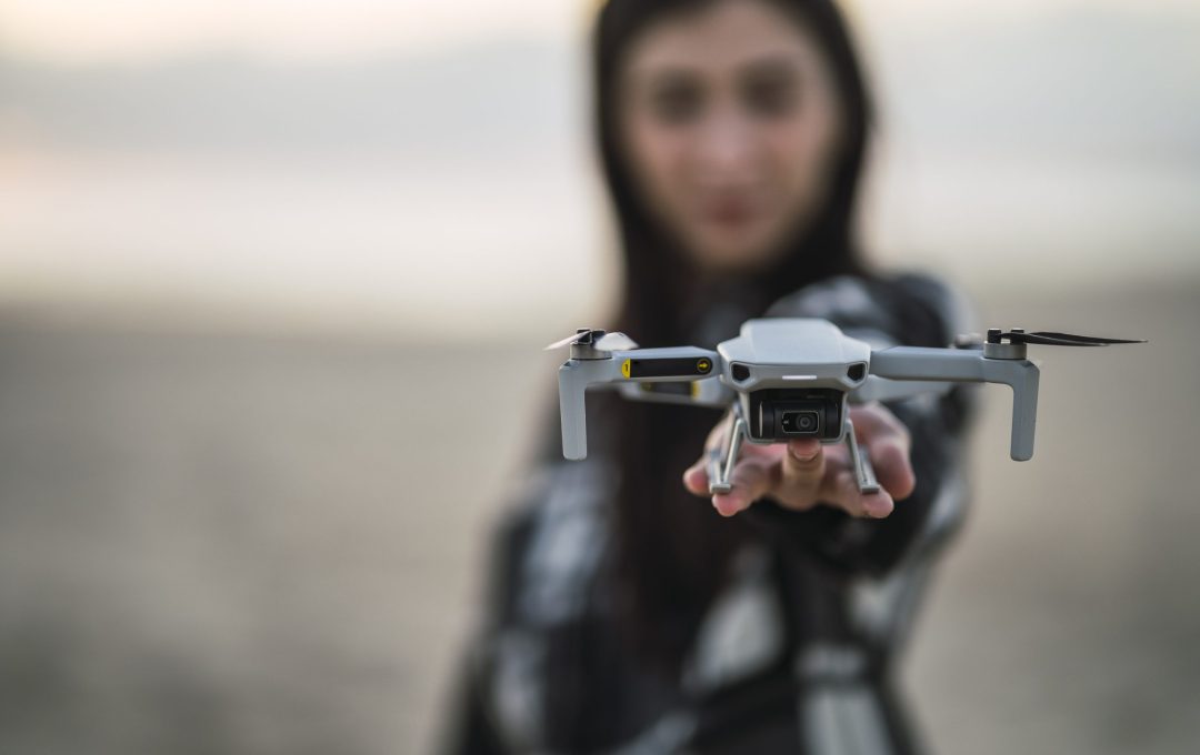 A selective focus of drone on the hand of a young Caucasian girl from Spain